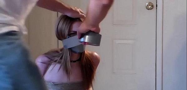  Cute redhead nicely gagged and tied with tape